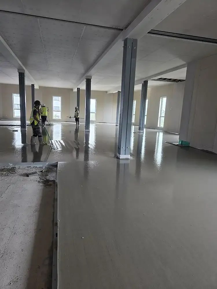 Trent crew levelling pumped flowing screed across an upper floor